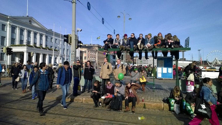 Bunch of people on top of a bus stop